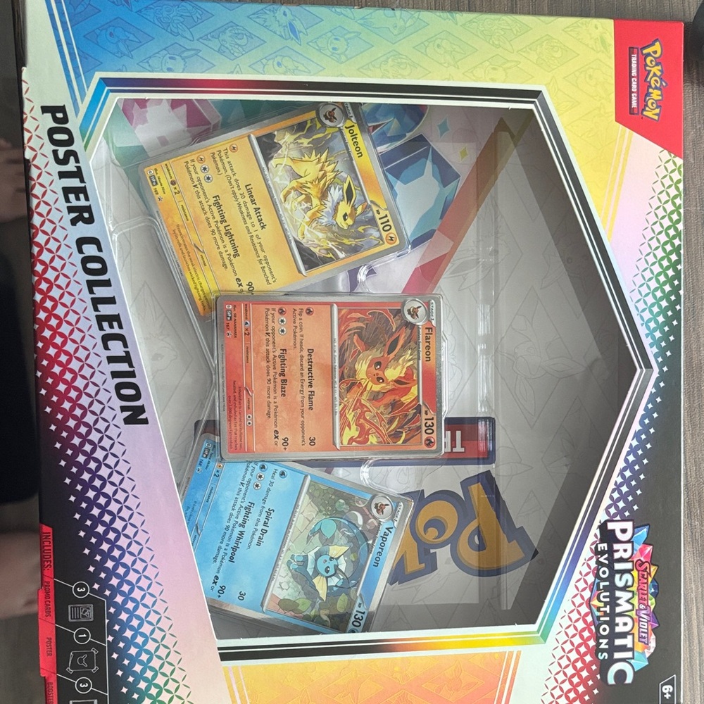 Pokemon Prismatic Evolutions Card Display with Red, Blue, Yellow